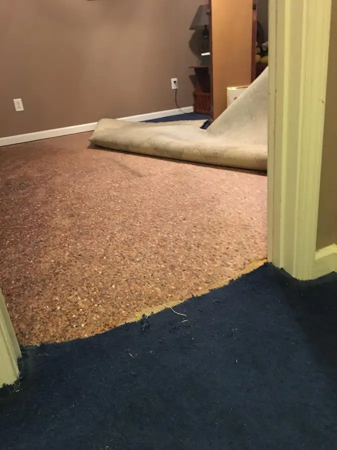 Carpet pad removal revealing water damage during Water Mitigation Services in Rapid Valley